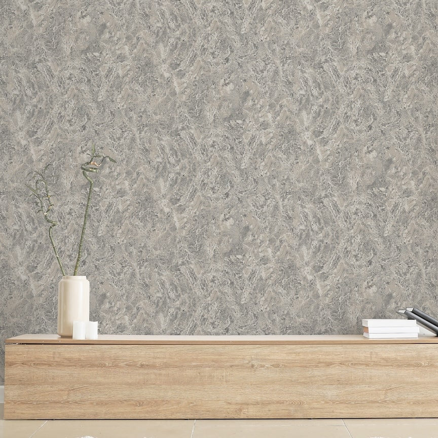 Gray textured wallpaper with a wooden shelf and decorative items in the foreground.