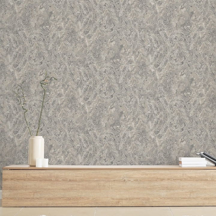Gray textured wallpaper with a wooden shelf and decorative items in the foreground.