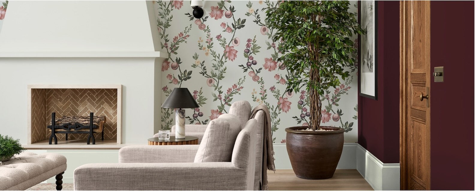 Decor Warehouse Sale up to 25% off wallpaper - wide span Image of a living room decorated in a white wallpaper featuring vertical pink floral trails.